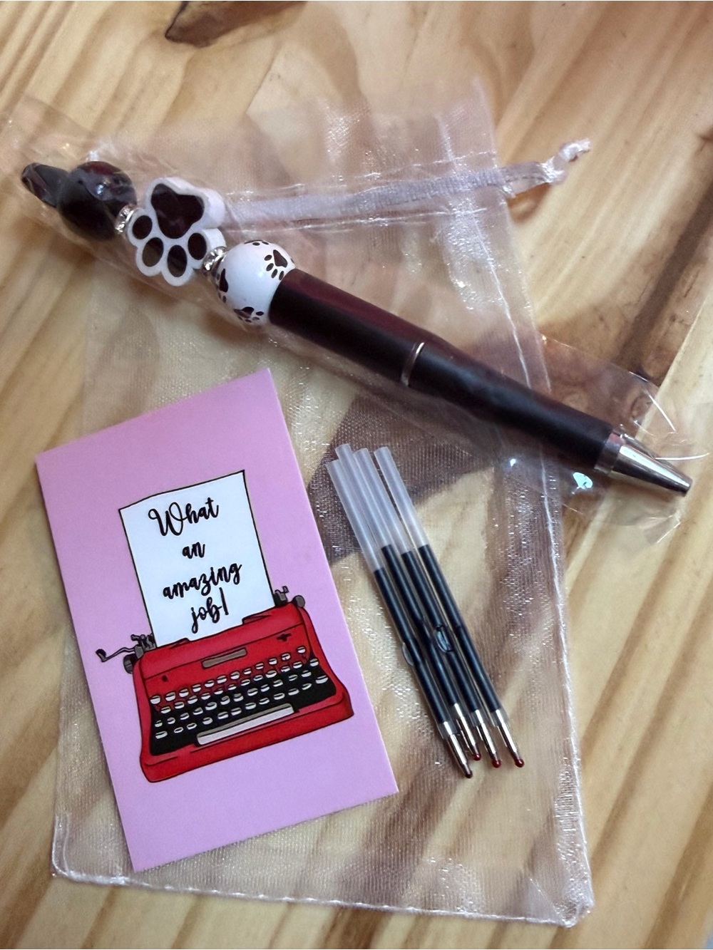 Cute Paw Charm Ballpoint Pen in Black and white.